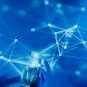 Futuristic robotic hand touching a digital network on a blue background.